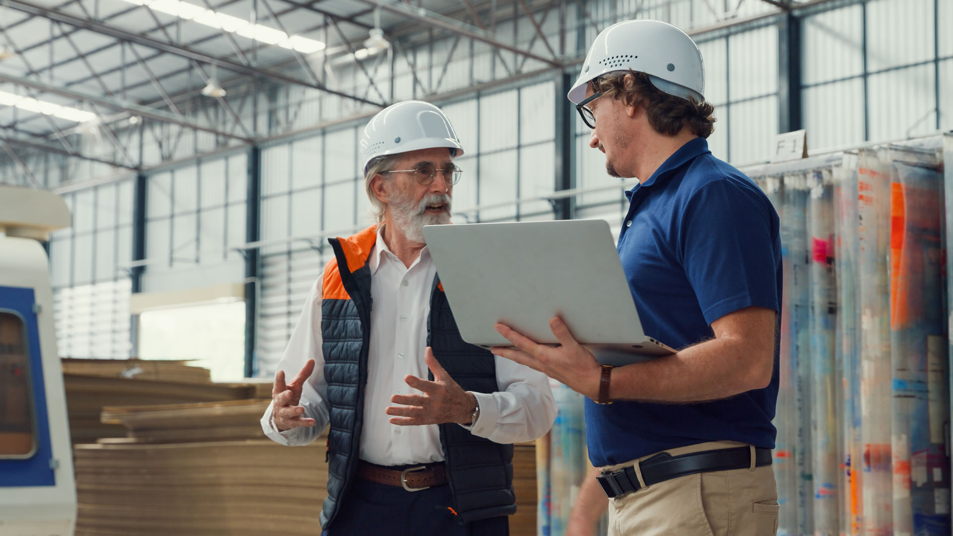 A project management team analyzing logistics data and charts on a glass board, collaborating on strategic industrial project solutions